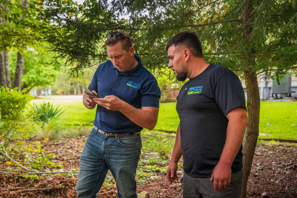 Crew reviewing plans for a fence installation, Rhode Island.