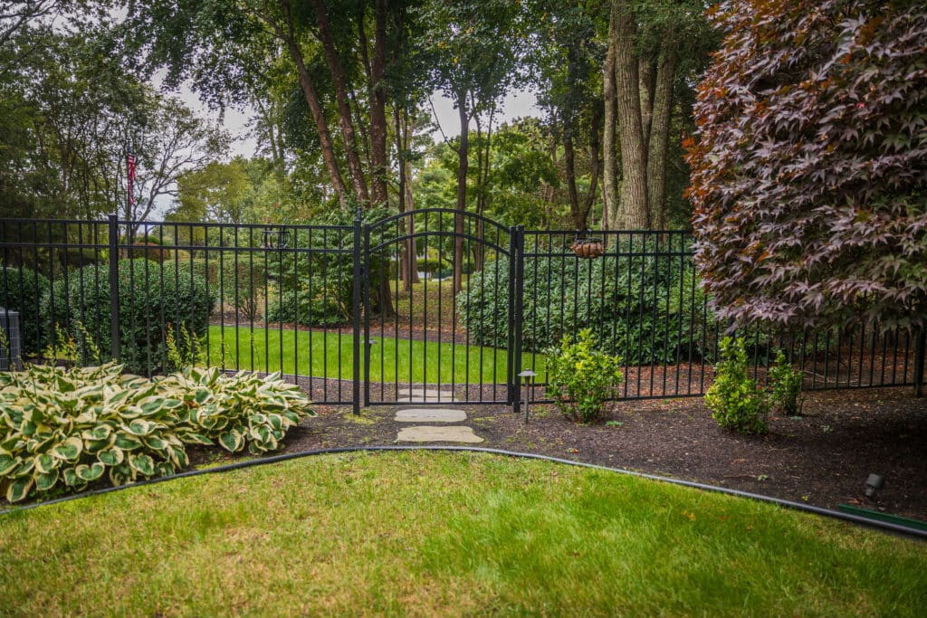 Decorative fence enclosing a garden, Rhode Island.