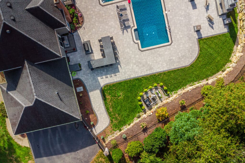 Aerial view of a residential outdoor pool with a surrounding fence, Rhode Island.