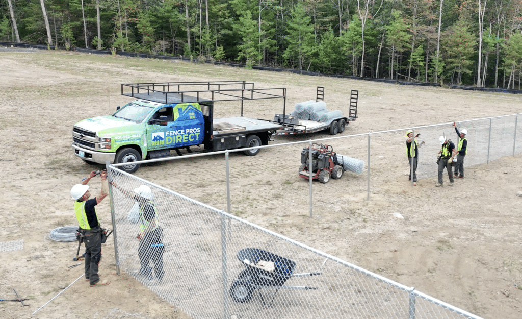 Crew installing a chain link fence, Rhode Island.