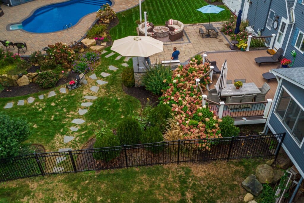 Different types of pool fences displayed around a swimming pool.